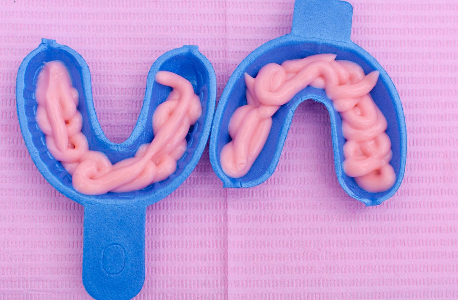 Two dental trays with fluoride treatment